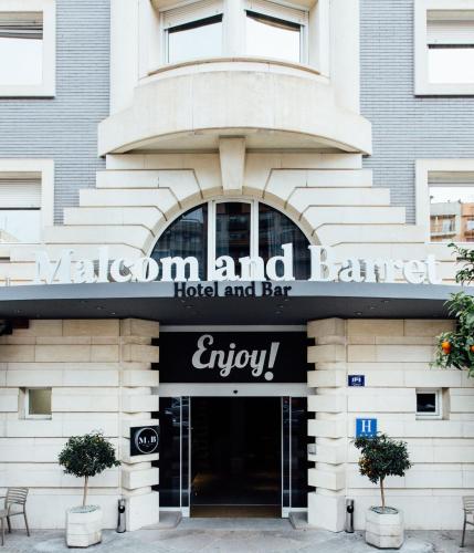 a hotel and bar sign in front of a building at Hotel Malcom and Barret in Valencia
