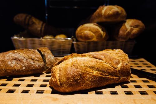 three loaves of bread are sitting on a table at Hotel Malcom and Barret in Valencia