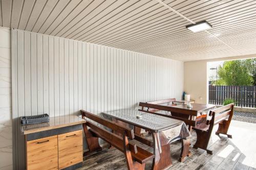 a dining room with two tables and wooden benches at Kredo in Solotvyno