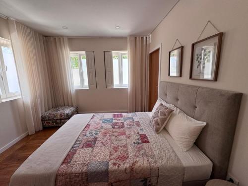 a bedroom with a bed with a quilt on it at Luna Navegante in Porto