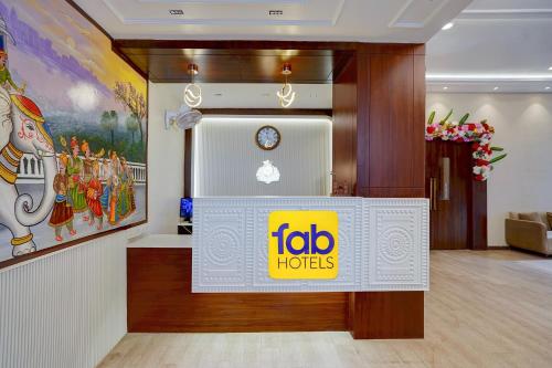 a foto h hotels sign on a wall in a room at FabHotel SV Grand I in Varanasi