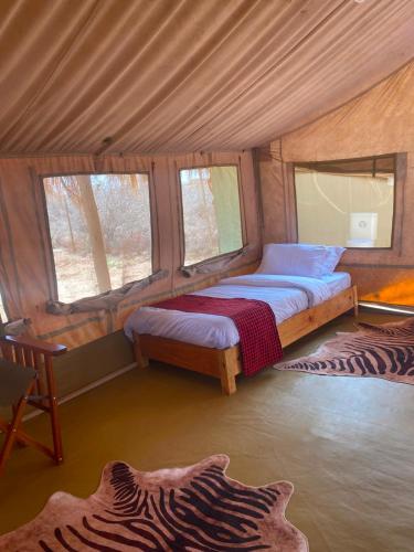 a bedroom with two beds in a tent at Samburu Tempo Camp in Archers Post