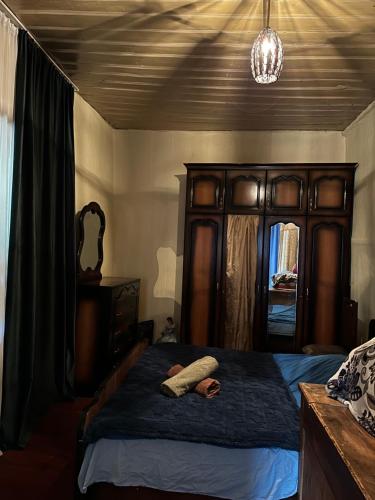 a bedroom with a bed with a wooden head board at Dadu Guest house in Davberi