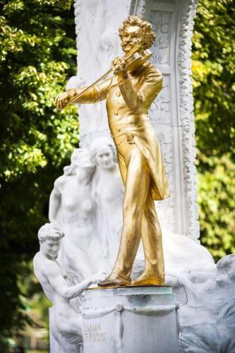 a statue of a man playing a violin at Lindner Hotel Vienna Am Belvedere, part of JdV by Hyatt in Vienna