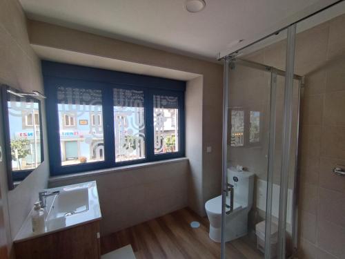 a bathroom with a toilet and a sink and a shower at SeiaVilla - São Pedro in Seia