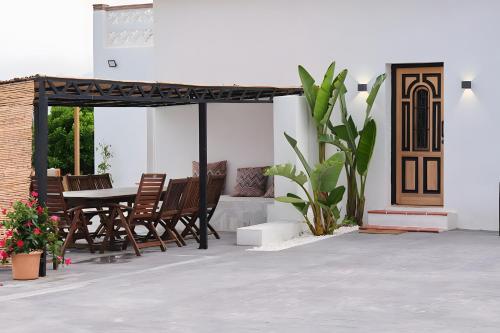 a patio with a table and chairs at Villa Raziel in Cártama