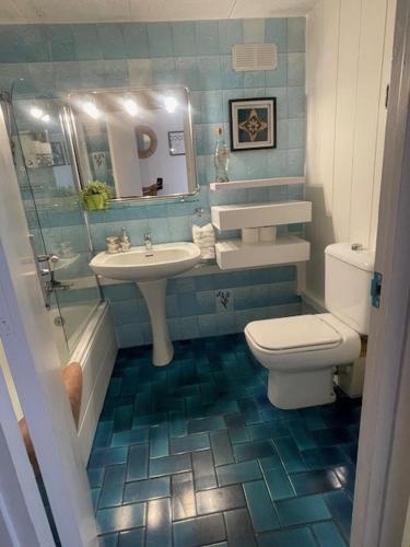 a bathroom with a toilet and a sink at The Hollidays Apartment in Calella