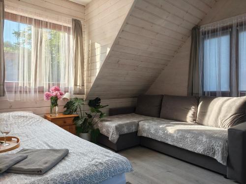 a living room with a couch and a window at ekoLOKUM in Ostróda
