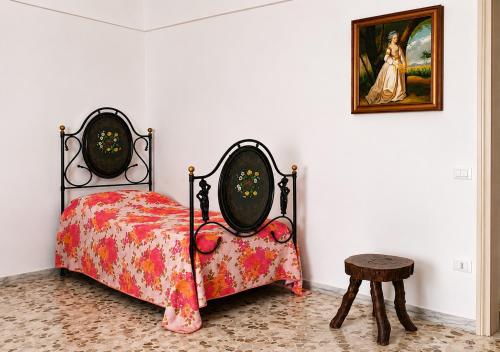 a bedroom with a bed and a picture on the wall at Casa Mare con finestra su balcone in Polignano a Mare
