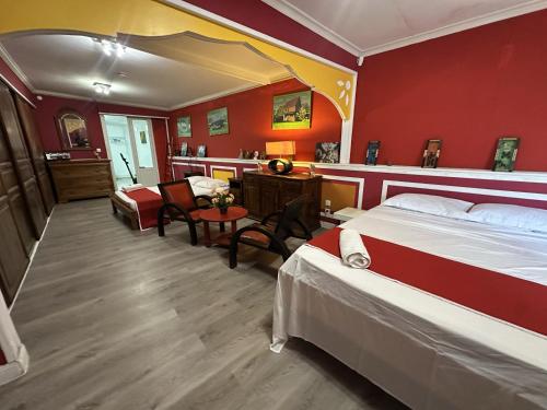 a bedroom with two beds and a table and chairs at Le coin des romarins in Saint-André