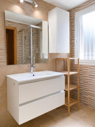 a bathroom with a white sink and a mirror at Villa La Perla - Pool, Garden & Barbecue - AC in Mutxamel