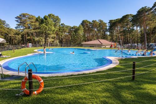 a large swimming pool with people in it at Kampaoh Picos de Urbión in Abejar