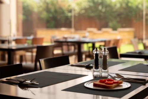 a table with a plate of food on top of it at Park Inn by Radisson Al Khobar in Al Khobar