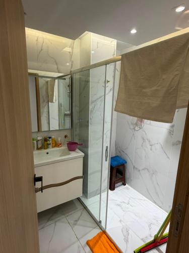 a bathroom with a shower and a sink at appartement de luxe tanger in Tangier