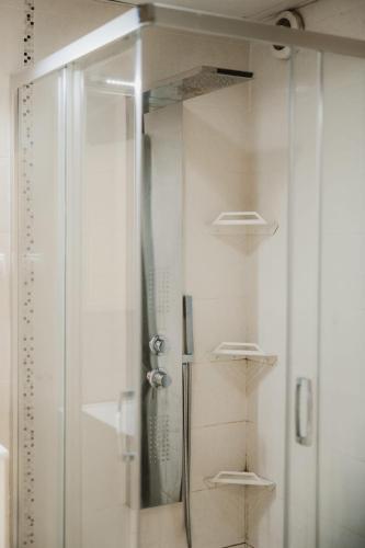 a shower with a glass door in a bathroom at The Red Lounge in Strumica