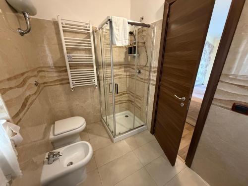 a bathroom with a shower and a toilet and a sink at Villa Anté B&B in Angri