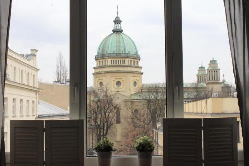 a window view of a building with a dome at Noctis Apartment Nowogrodzka in Warsaw