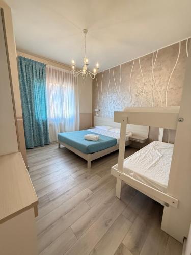 a bedroom with a bed and a table in it at Mar ricco Room 5 in Chioggia