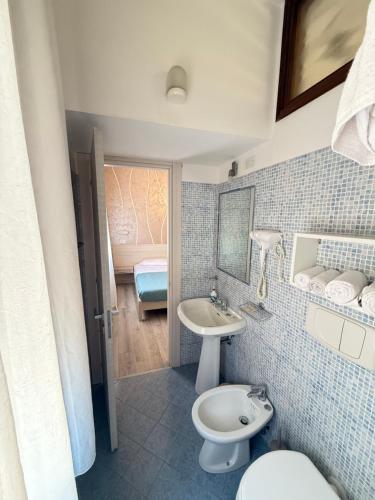 a bathroom with a toilet and a sink at Mar ricco Room 5 in Chioggia