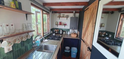 a small kitchen with a sink and a counter at Tiny House Lau at Glamping Verbaarum in Bedum