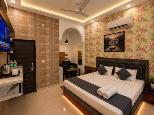 a bedroom with a bed and a tv in a room at Hotel The Montana Suite - Free Airport and Aerocity Pickup & Drop in New Delhi