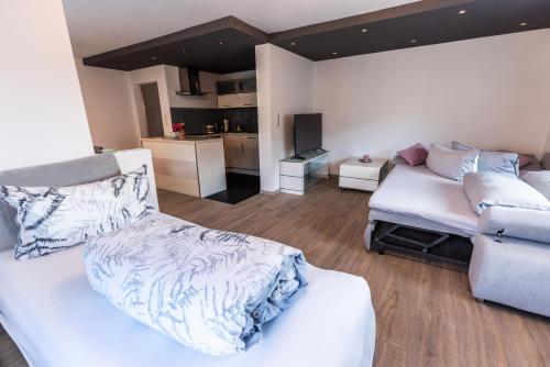 a living room with a bed and a couch at Pension Ferienwohnung Pirhofer in Kramsach