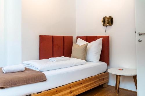 a bed with white sheets and pillows in a room at VINCENT Loft in der Innenstadt - mit Garage in Bregenz