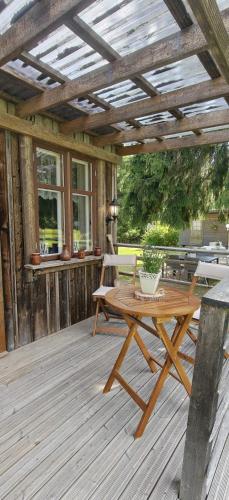a wooden patio with a table and chairs on a deck at Raju - Guest House in Seinäjoki