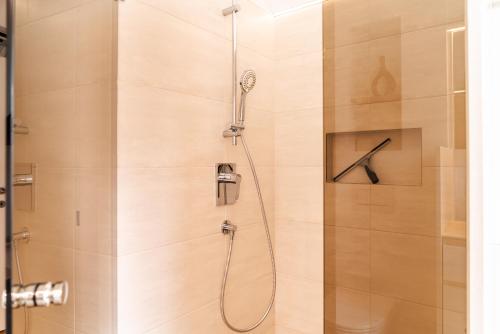 a shower in a bathroom with a glass door at VINCENT Loft in der Innenstadt - mit Garage in Bregenz