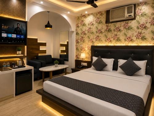 a bedroom with a bed and a living room at Hotel Bell Montana Stay Near IGI Airport Delhi- Free Airport Pickup & Drop in New Delhi