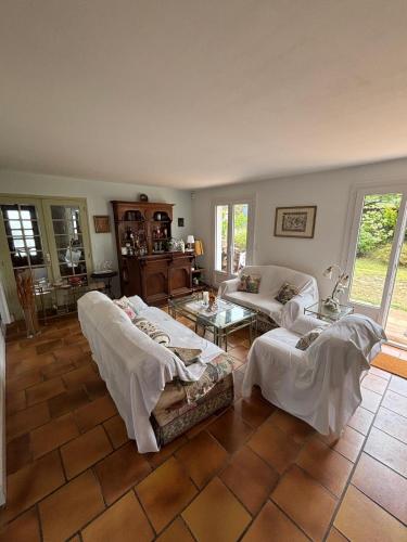 a living room with two beds and a couch at Villa Azkanean in Bidart