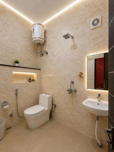 a bathroom with a toilet and a sink at Hotel Bell Montana Stay Near IGI Airport Delhi- Free Airport Pickup & Drop in New Delhi