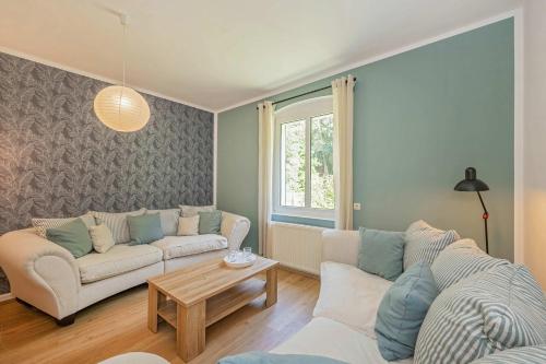 a living room with a couch and a table at Ferienhaus Oscar in Garz