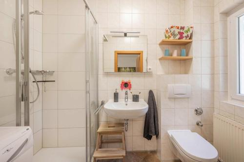 a white bathroom with a sink and a shower at Ferienwohnung Emily in Garz