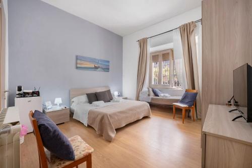 a bedroom with a bed and a living room at Home Joséphine - Caserta in Caserta