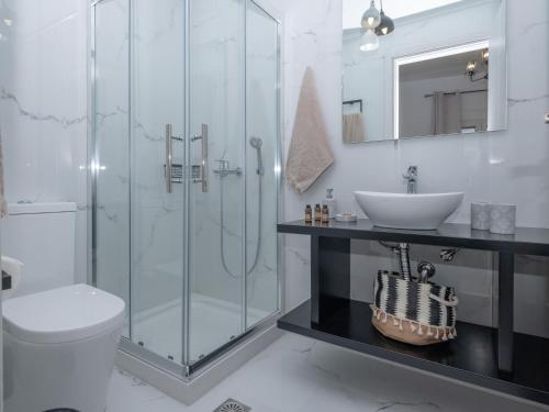 a bathroom with a shower and a toilet and a sink at Sea Memories Villa in Skaleta