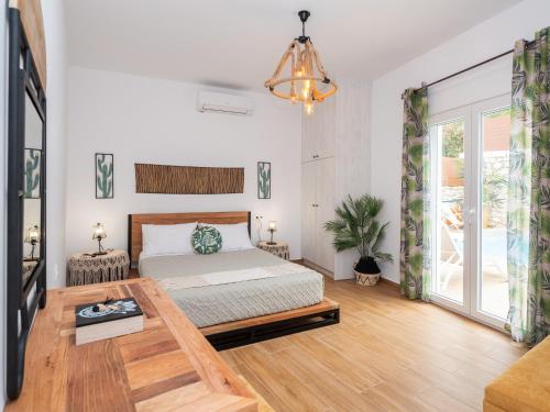 a bedroom with a bed and a table at Sea Memories Villa in Skaleta