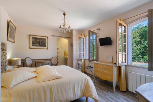 a bedroom with a bed and a dresser and a window at La Table De Pierre - Chambre d'Hôte in Lussas-et-Nontronneau
