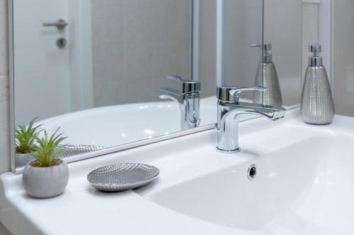a bathroom sink with a faucet and a mirror at RELAX APARTMENT in the Mountains in Valdieri