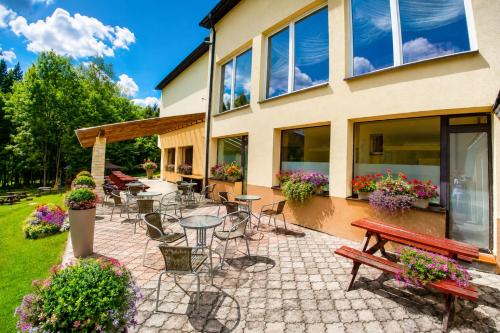 a patio with tables and chairs in front of a house at Dom Wczasowy GLOBUS in Ustroń