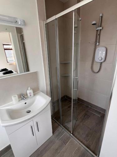 a bathroom with a sink and a shower at Clohanbeg School House in Kilrush