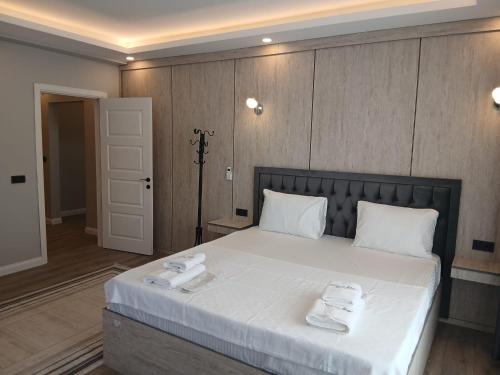 a bedroom with a large bed with two towels on it at Sunset hill in Büyükçekmece