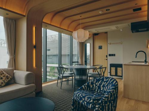 a living room with a couch and a table at illi Sen Oshiage in Tokyo