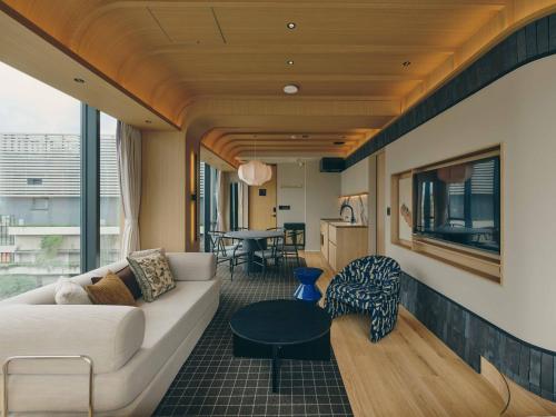 a living room with a couch and a table at illi Sen Oshiage in Tokyo