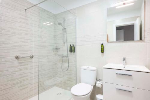 a bathroom with a shower and a toilet and a sink at Ona Las Brisas in Playa Blanca