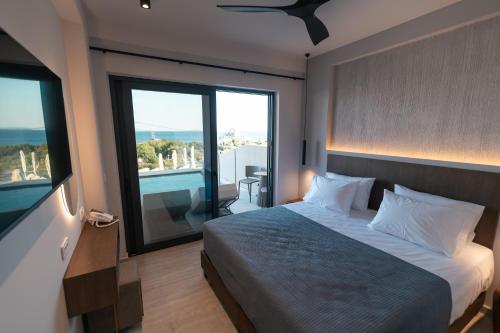 a bedroom with a bed and a large window at Kefalos View in Vrachonisída Palaiókastro