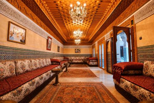 a waiting room with couches and a chandelier at Palais Riad Reda & Spa in Fez