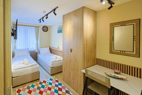 a small room with a bed and a mirror at FourMountains-Trebević in Sarajevo