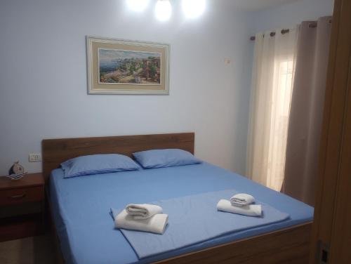 a bedroom with a bed with two towels on it at Seaside Nest Shengjin in Shëngjin