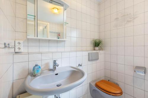 a bathroom with a sink and a toilet at Erholungspark Wilhelmsruh in Möhnesee